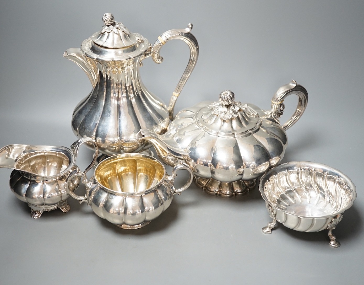 A matched harlequin 19th and 20th century fluted silver four piece tea set, teapot The Barnards, London, 1838, sugar bowl Edward & John Barnard, London, 1857, cream jug marks rubbed, and coffee pot William Hutton & Sons,